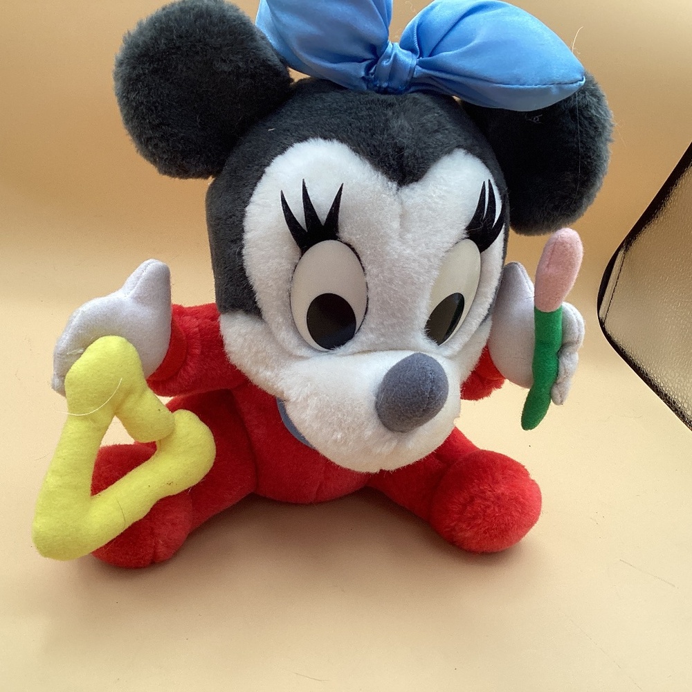 Disney Baby Minnie Mouse playing with a triangle